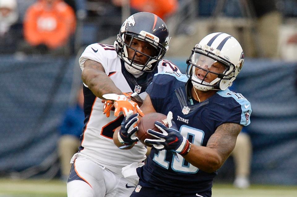 Titans wide receiver Rishard Matthews fights Broncos defender Aqib Talib for the ball.